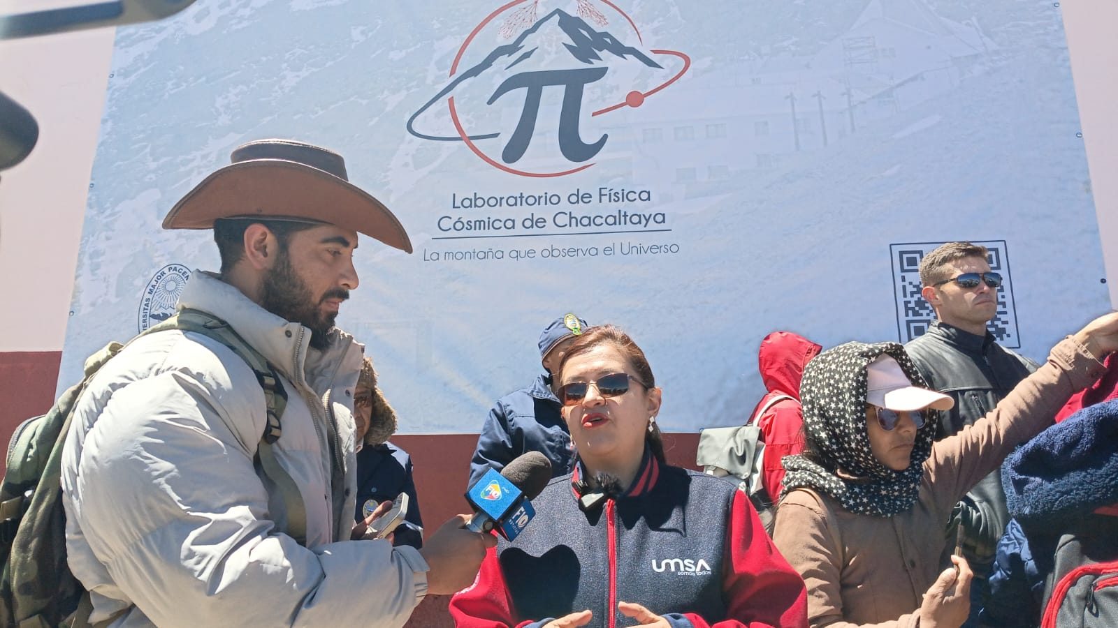 La rectora de la Universidad Mayor de San Andrés, María Eugenia García, atiende a la prensa al pie del lienzo.